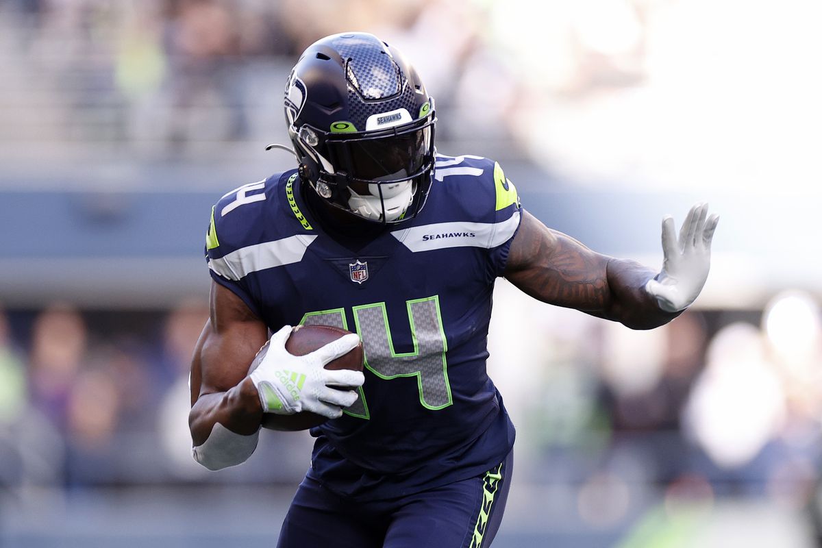 SEATTLE, WASHINGTON - NOVEMBER 27: DK Metcalf #14 of the Seattle Seahawks carries the ball during the first quarter against the Las Vegas Raiders at Lumen Field on November 27, 2022 in Seattle, Washington.