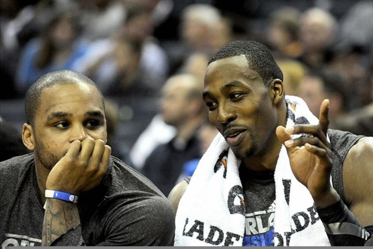 March 6, 2012; Charlotte, NC, USA; Orlando Magic center Dwight Howard (12) talks to guard Jameer Nelson (14) during the game against the Charlotte Bobcats at Time Warner Cable Arena. Mandatory Credit: Sam Sharpe-US PRESSWIRE