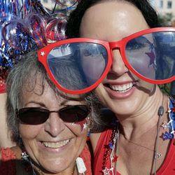 Judy Chastain, left, and Misty Gencarelle dance around as they wait in line to attend a campaign rally for President Donald Trump, Tuesday, June 18, 2019, in Orlando, Fla. (AP Photo/John Raoux)