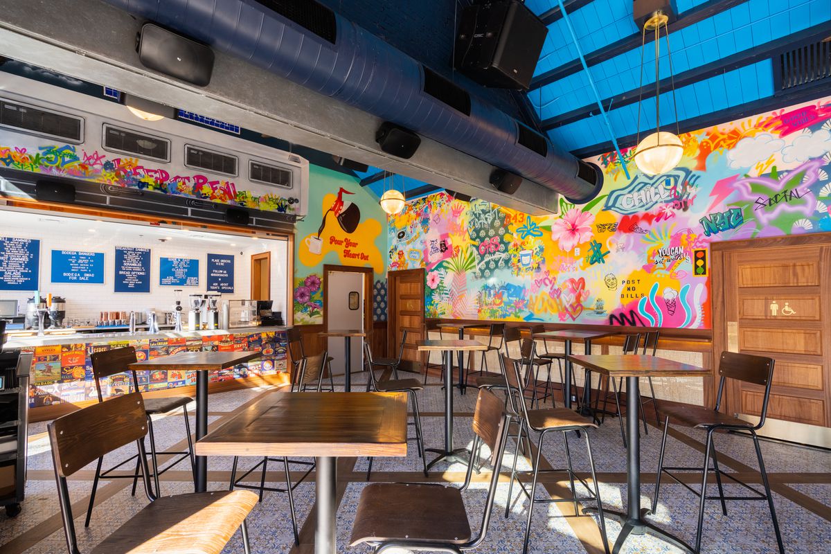 Dining room with a colorful graffiti wall.