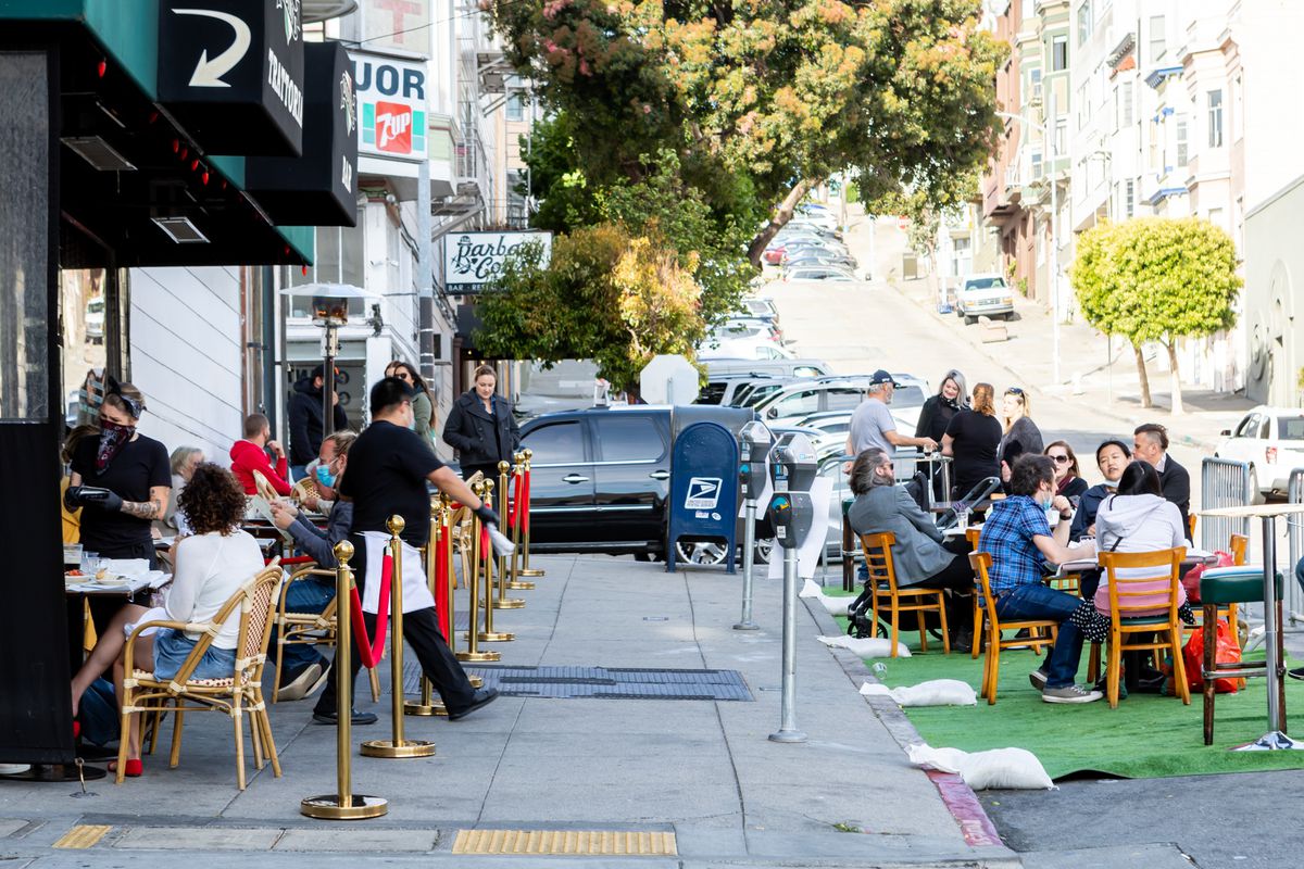Diners at Sodini’s Trattoria are seated both on the sidewalk and in the parking spaces in front of the restaurant