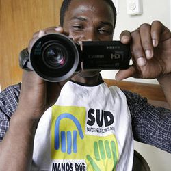 Interpreter/driver Daniel Delva gets a kick out of seeing what a video camera can do in Port-au-Prince on Jan. 20.