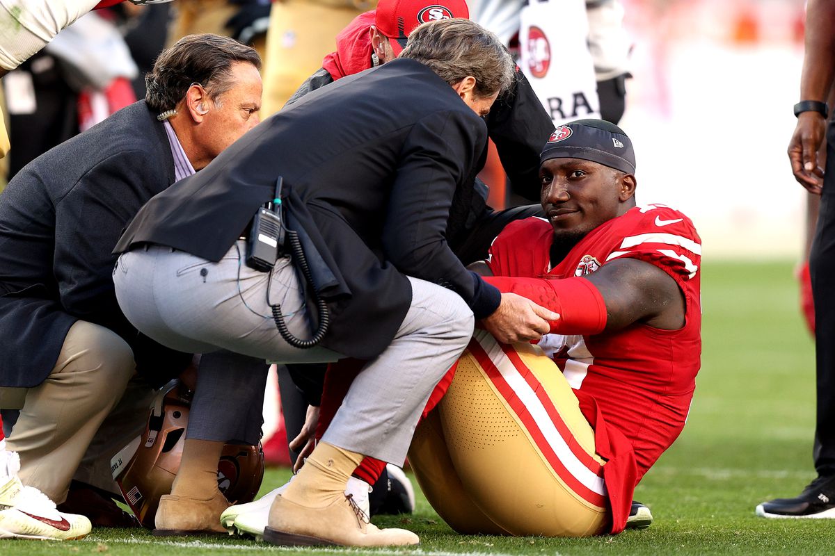 Deebo Samuel #19 of the San Francisco 49ers is attended to by team trainers after an injury on the field in the third quarter during the game against the Minnesota Vikings at Levi’s Stadium on November 28, 2021 in Santa Clara, California.