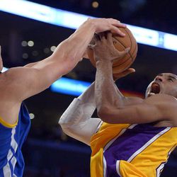 Golden State Warriors forward Andris Biedrins, of Latvia,, left, blocks the shot of Los Angeles Lakers guard Kobe Bryant during the first half of their NBA basketball game, Friday, April 12, 2013, in Los Angeles. 