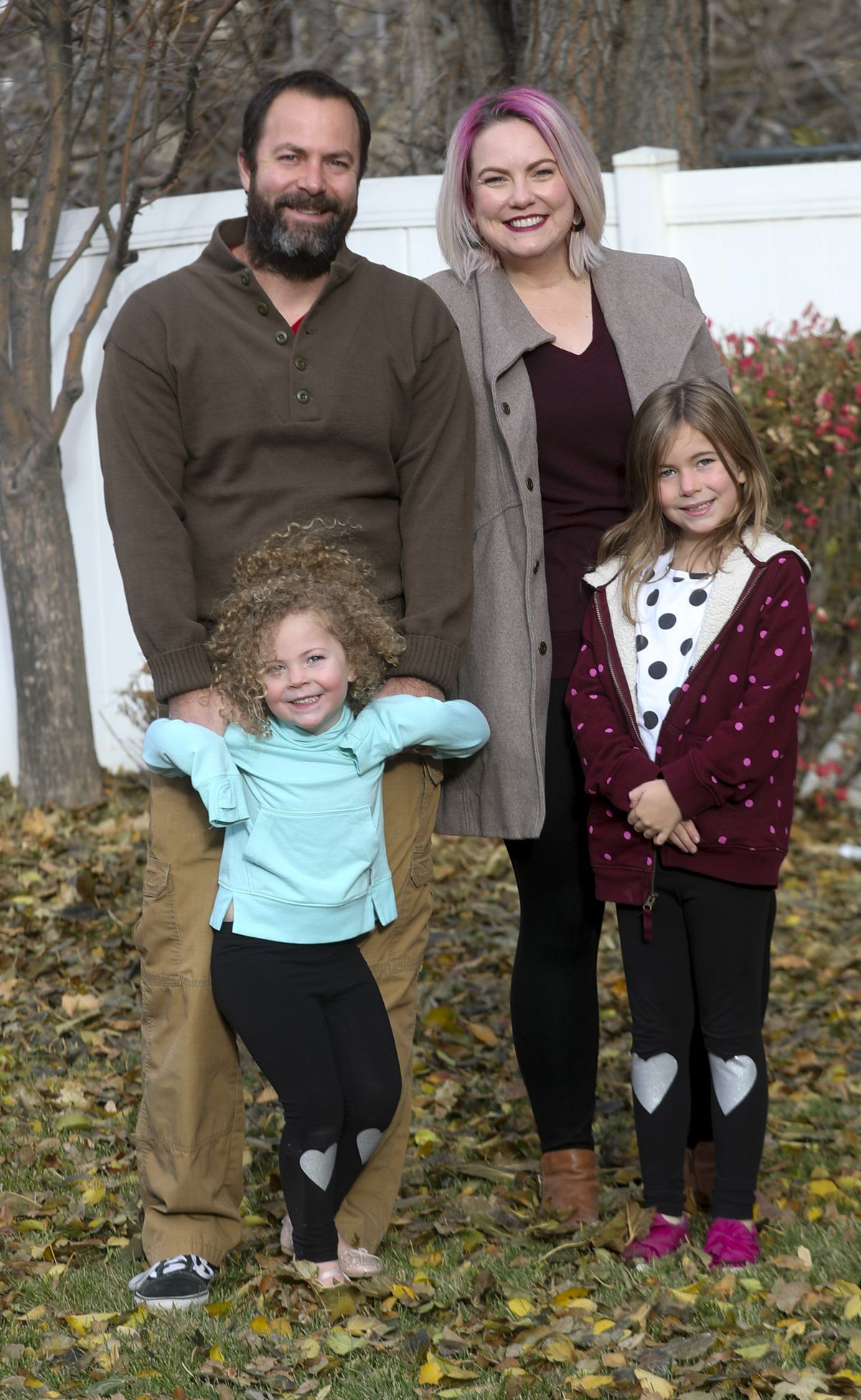 John Hepworth, back left, and his wife, Jen, back right, pose for a photo with daughters Sadie, front left, and Penny, front right, in the backyard of their home in Layton on Tuesday, Nov. 10, 2020.