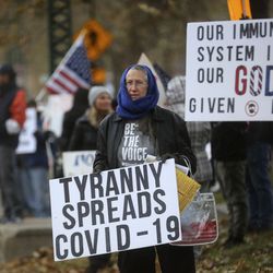 Protesters gather outside of the Governor’s Mansion to protest Gov. Gary Herbert’s mask mandate and new COVID-19 restrictions in Salt Lake City on Monday, Nov. 9, 2020.