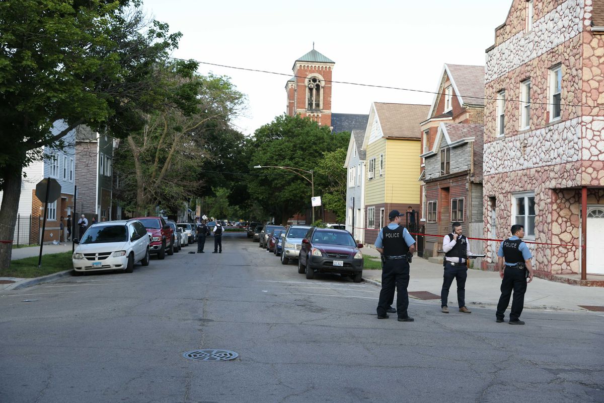 Police investigate the scene were a 14-year-old girl was shot and critically wounded June 2, 2021 in the 1700 block of West 48th Street.