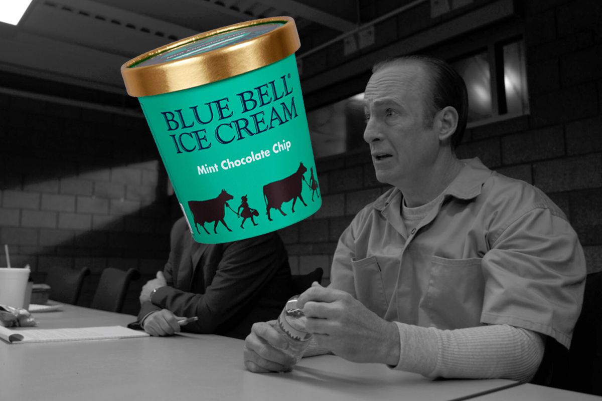 A black-and-white image of a balding man in a collared shirt sitting at a table with a big colored image of a green ice cream carton with a green table and the black words of Blue Bell Ice Cream and black cows and people with a gold lid a