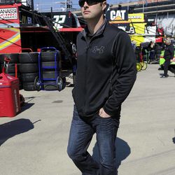 NASCAR driver Travis Kvapil walks through the garage at Atlanta Motor Speedway Friday, Feb. 27, 2015, in Hampton, Ga. Kvapil's NASCAR Sprint Cup car was stolen early Friday, forcing him to withdraw from a race this weekend at Atlanta Motor Speedway. A trailer with the red No. 44 car inside was hitched to a black 2004 Ford F-350 pickup truck parked outside a hotel in Morrow, Georgia, about 15 miles south of Atlanta, police said. Surveillance video shows the truck and trailer being driven out of the parking lot around 5:30 a.m., Morrow police Detective Sgt. Larry Oglesby said.