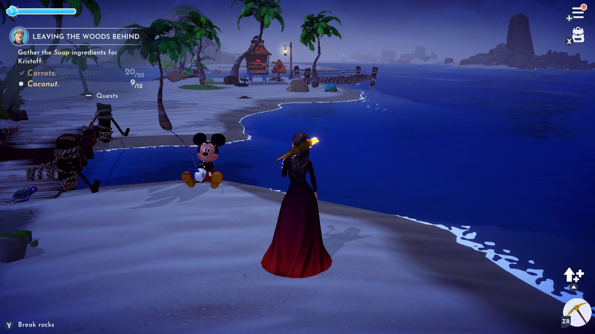 mickey mouse fishing on a beach, except he faces the sand. a figure in a long red dress stands over him