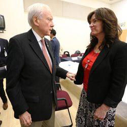 FILE - Senator Orrin Hatch talks with Laura Warburton who lost her daughter Hannah to suicide, as he convenes a suicide-prevention conference at East High School  in Salt Lake City on Friday, Dec. 16, 2016.