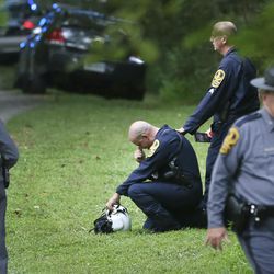 Authorities work near the scene of a deadly helicopter crash near Charlottesville, Va., on Saturday Aug. 12, 2017. 