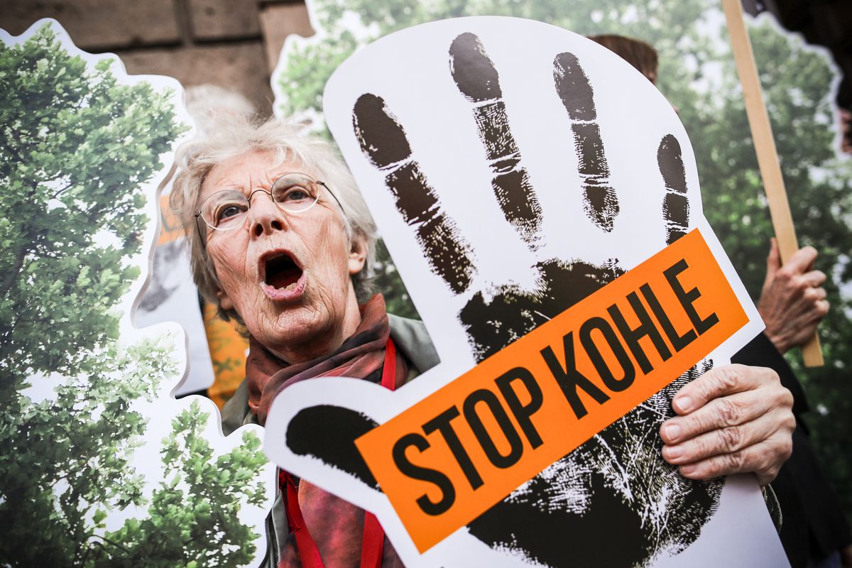 An environmentalist holds a placard reading “Stop Coal” as she demonstrates against coal energy in front of the Germany’s Federal Economy Ministry in Berlin, on October 12, 2018.