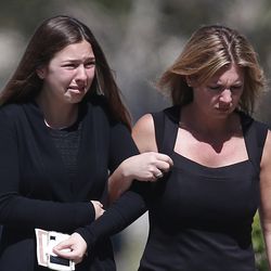 A young girl and a woman embrace as they leave a funeral service for Alyssa Alhadeff at the Star of David Funeral Chapel in North Lauderdale, Fla., Friday, Feb. 16, 2018. Alhadeff was one of the victims of Wednesday shooting at Marjory Stoneman Douglas High School. Nikolas Cruz, a former student, was charged with 17 counts of premeditated murder. (AP Photo/Brynn Anderson)