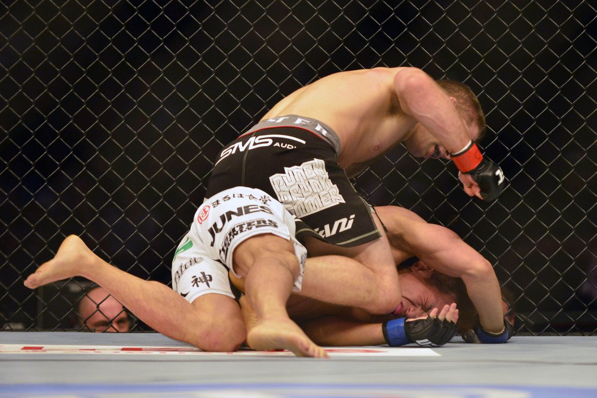 August 11, 2012; Denver, CO, USA; Nik Lentz (top) fights Eiji Mitsuoka (bottom) during UFC 150 at the Pepsi Center. Mandatory Credit: Ron Chenoy-US PRESSWIRE