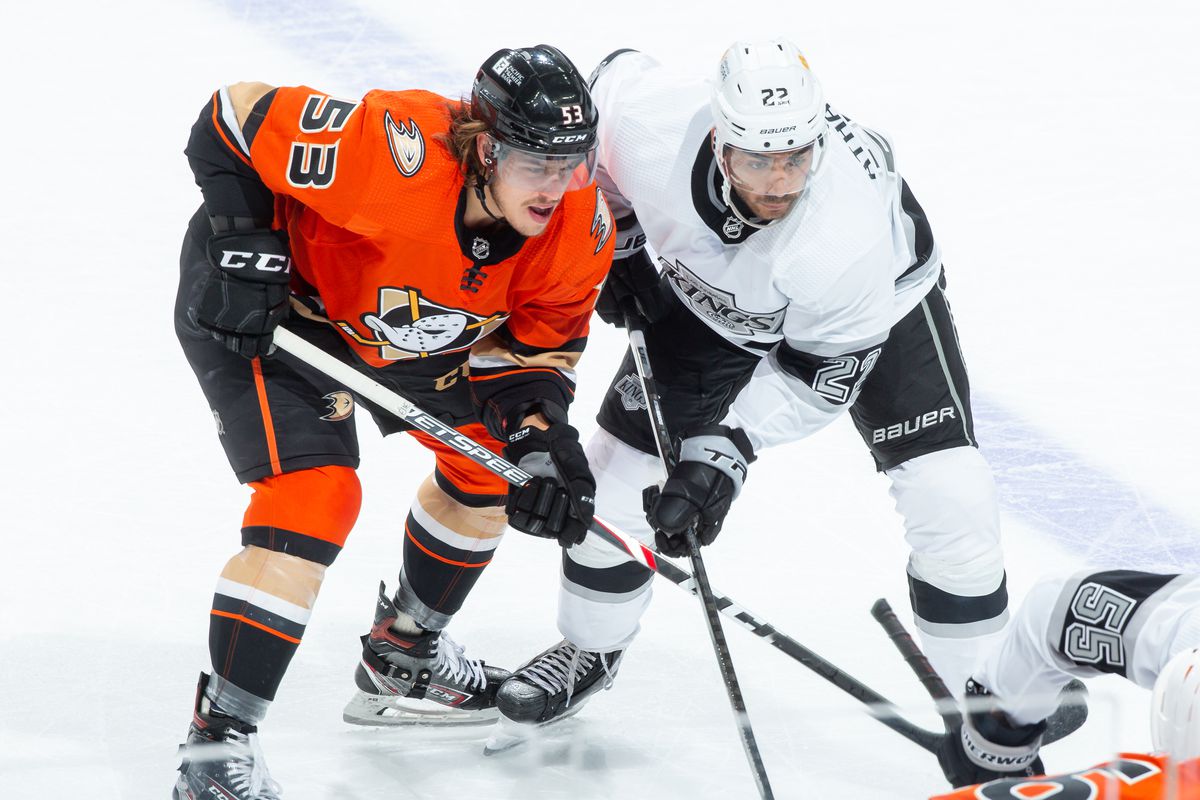 Max Comtois #53 of the Anaheim Ducks and Andreas Athanasiou #22 of the Los Angeles Kings battle for position as the wait for a face-off during the third period of the game at Honda Center on April 30, 2021 in Anaheim, California.