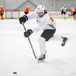 Jackson Cates (C) hits the puck during practice drills at day two of Flyers development camp
