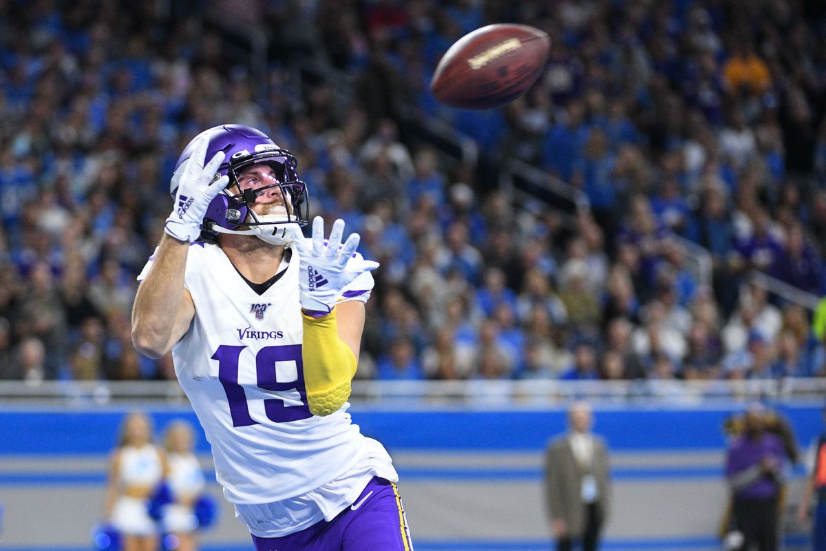 Minnesota Vikings wide receiver Adam Thielen scores a touchdown and is injured during the play during the first quarter against the Detroit Lions at Ford Field.