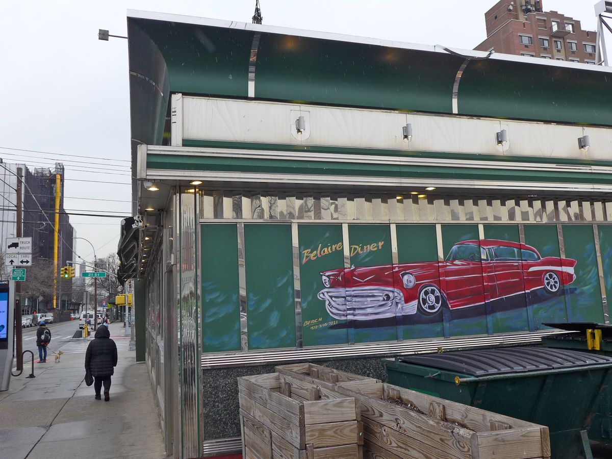 A red car from the 60s painted on an exterior wall.