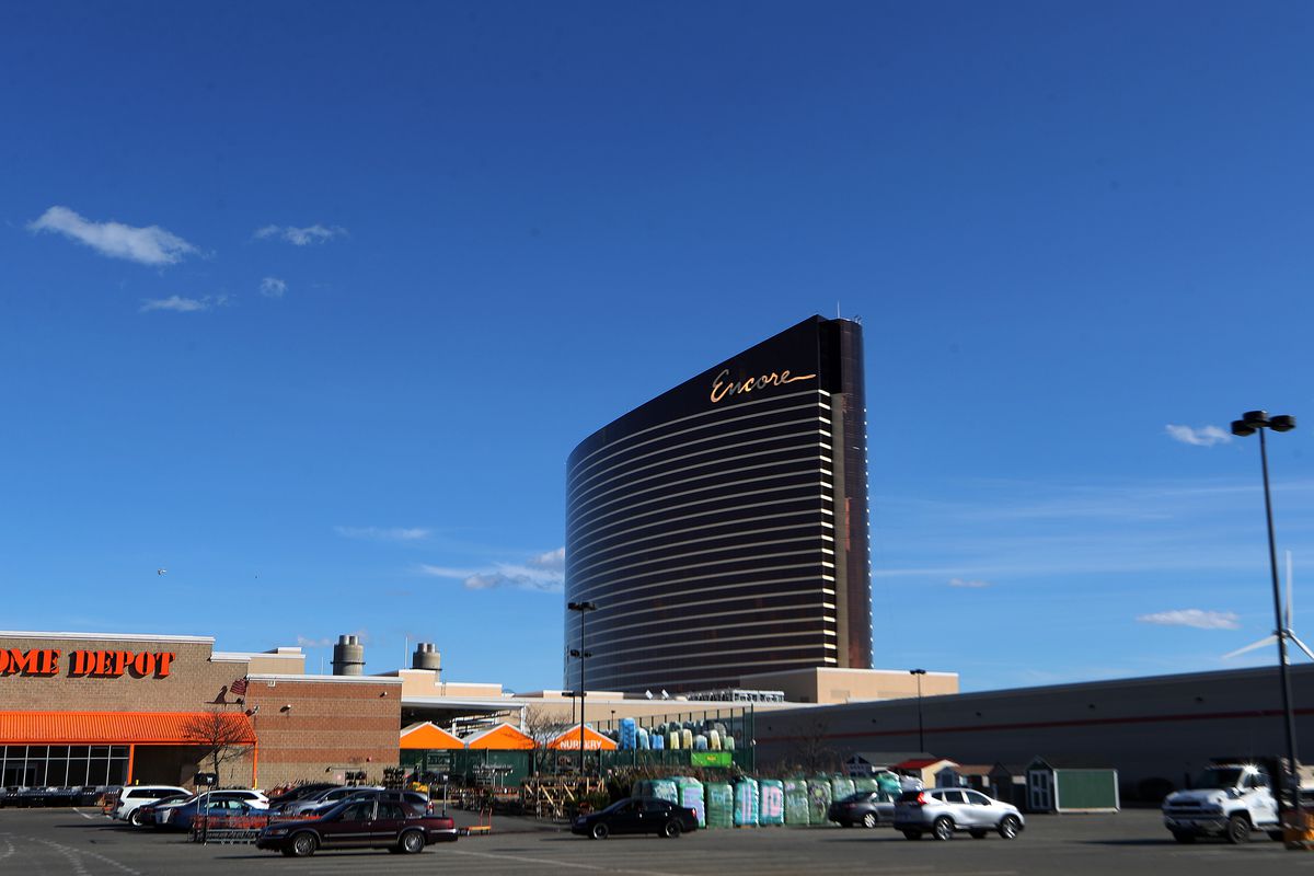 A large, rectangular, and curved building looming over a parking lot. 
