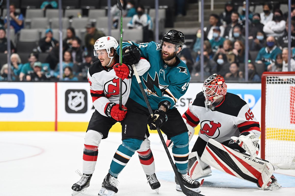 Jonah Gadjovich #42 of the San Jose Sharks battles for position in front of the net against Ty Smith #24 of the New Jersey Devils in a regular season game at SAP Center on November 6, 2021 in San Jose, California.