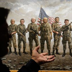 Artist Jon McNaughton points toward one of his paintings, “The Magnificent Seven,” at his studio in Utah County on Monday, Nov. 22, 2021.