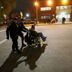 FILE — Salt Lake Police Sgt. Bill Manzanares and officer Harrison Livsey bring a homeless man to the winter overflow shelter at St. Vincent de Paul in Salt Lake City as it opens just ahead of a winter storm Wednesday, Nov. 16, 2016.