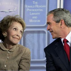 FILE - In this Oct. 21, 2005, file photo, President George W. Bush looks at former first lady Nancy Reagan during dedication ceremonies for the retired Air Force One Boeing 707 aircraft at the Ronald Reagan Presidential Library and Museum in Simi Valley, Calif. The former first lady has died at 94, The Associated Press confirmed Sunday, March 6, 2016. 