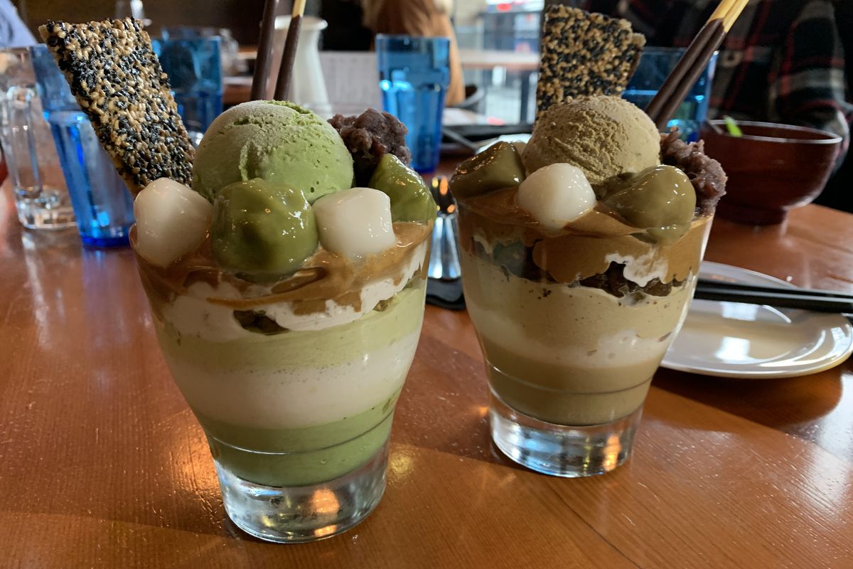 Closeup of green (matcha) and dark brown (hojicha) parfait bowls on a table at Rondo in Capitol Hill.