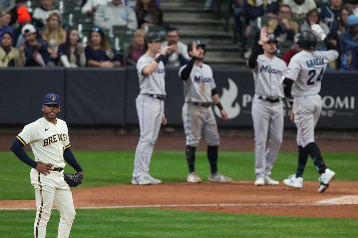 Milwaukee Brewers starting pitcher Freddy Peralta (51) looks away as Miami Marlins right fielder Avisail Garcia (24) crosses home plate after hitting a grand slam home run during the eighth inning of their game Thursday, September 29, 2022 at American Family Field in Milwaukee, Wis.
