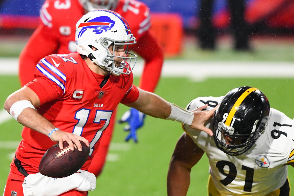 Buffalo Bills quarterback Josh Allen (17) avoids Pittsburgh Steelers defensive end Stephon Tuitt (91) while running with the ball during the second quarter at Bills Stadium.