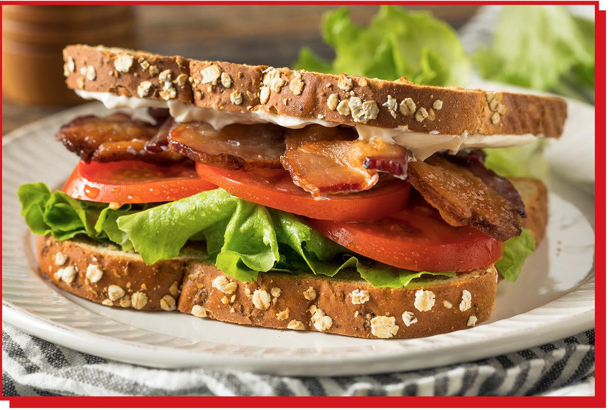 Sandwich with mayo, bacon, tomato, and lettuce layers between bread.