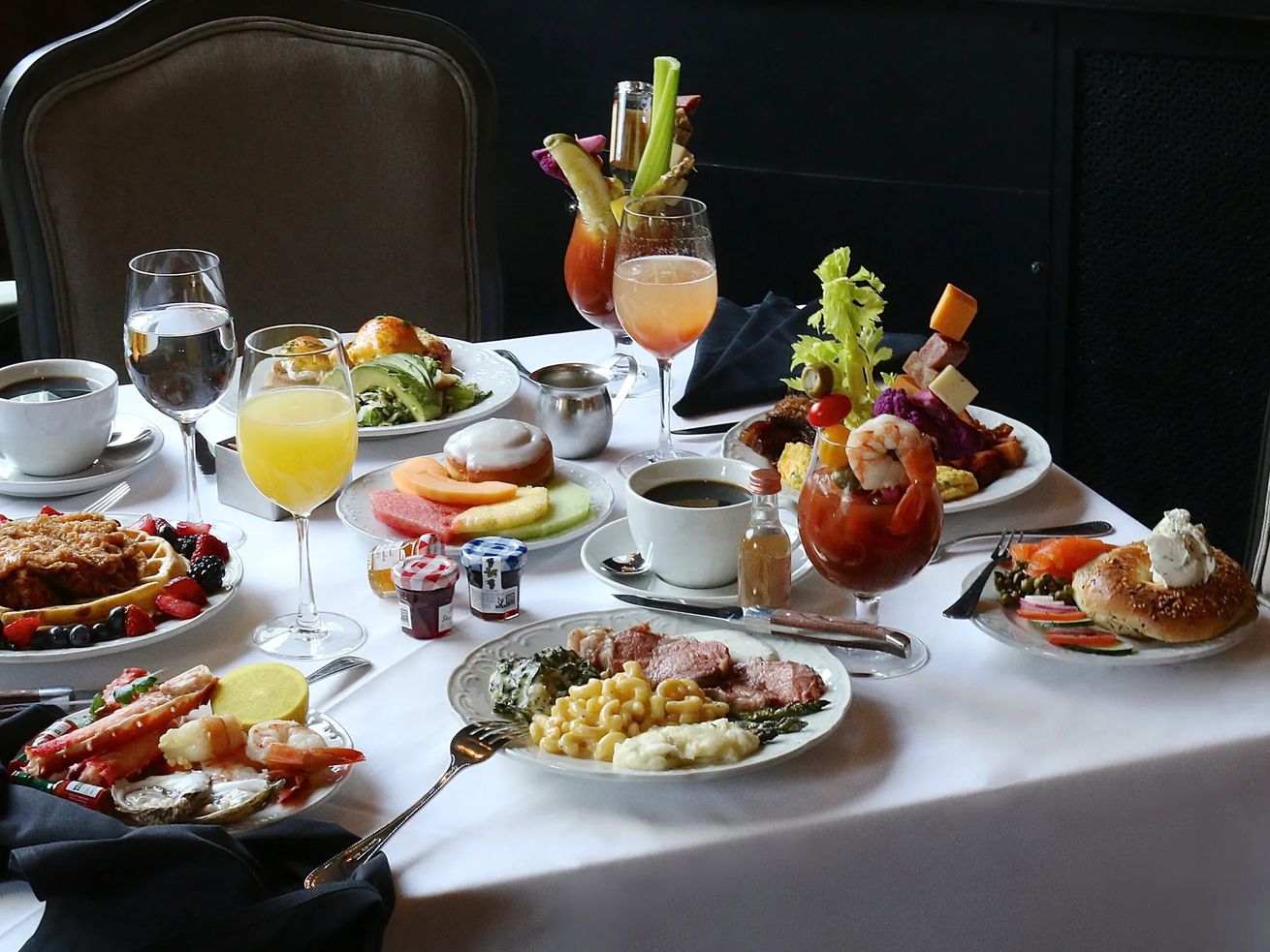 Brunch dishes and beverages spread out on a table.