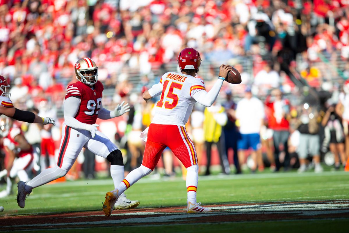 Patrick Mahomes #15 of the Kansas City Chiefs passes under pressure from Drake Jackson #95 of the San Francisco 49ers during the game at Levi’s Stadium on October 23, 2022 in Santa Clara, California. The Chiefs defeated the 49ers 44-23.