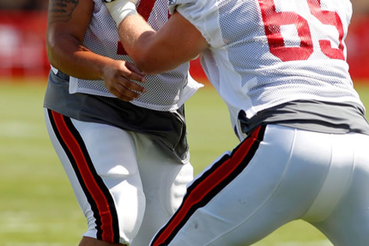 TAMPA - JULY 31:  Tackle Donald Penn #70 of the Tampa Bay Buccaneers works with Jeremy Trueblood #65 on a blocking drill during Training Camp at One Buccaneer Place on July 31 2010 in Tampa Florida.  (Photo by J. Meric/Getty Images)