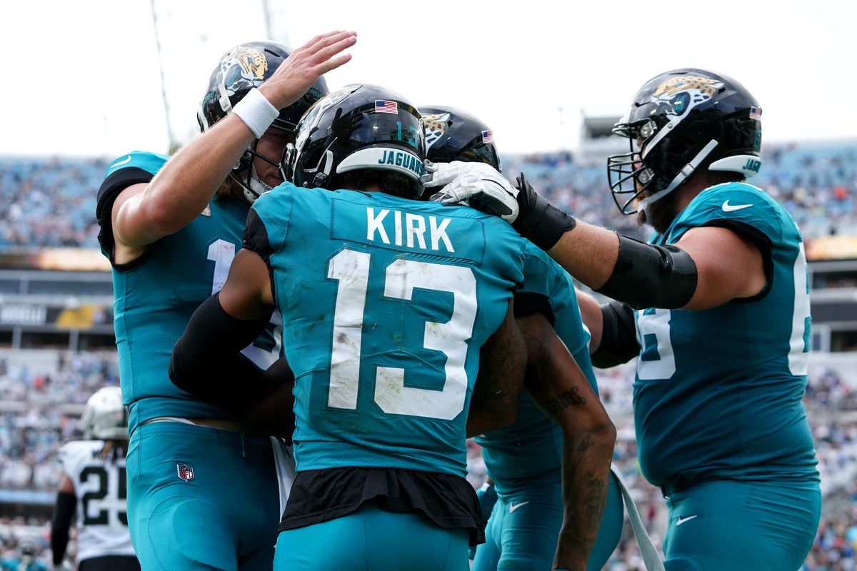 Christian Kirk #13 is congratulated by Trevor Lawrence #16, Marvin Jones Jr. #11 and Brandon Scherff #68 of the Jacksonville Jaguars after catching a touchdown pass in the third quarter of the game against the Las Vegas Raiders at TIAA Bank Field on November 06, 2022 in Jacksonville, Florida.