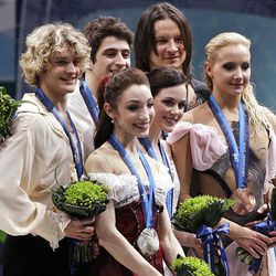 Canadian pair and gold medallists Tessa Virtue and Scott Moir, center; American pair and silver medallists Meryl Davis and Charlie White, left; and Russian pair and bronze medallists Oksana Domnina and Maxim Shabalin, right; are seen on the podium during the medals ceremony for the ice dance figure skating competition at the Vancouver 2010 Olympics Monday
