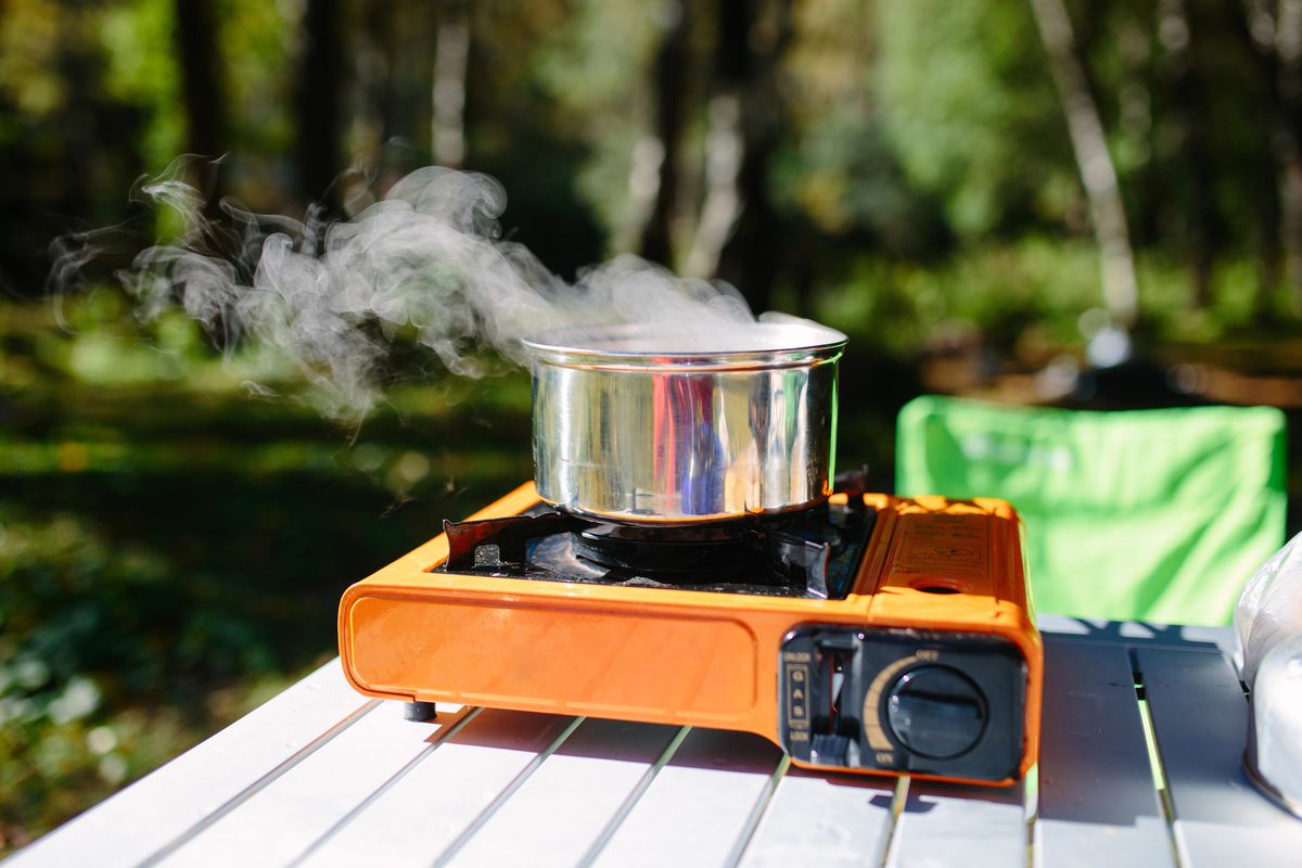 A pot on top of a portable gas burner