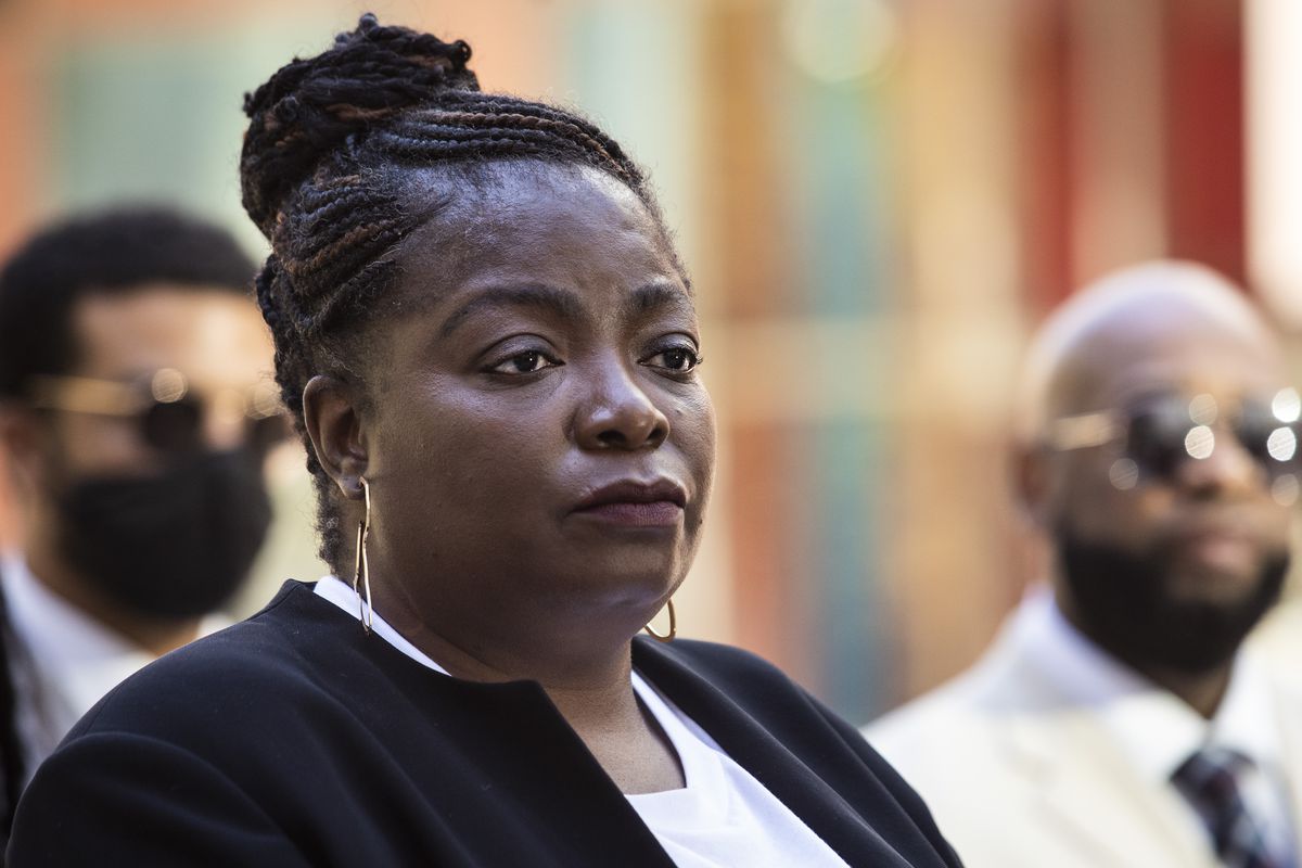 Flanked by attorneys and supporters, Anjanette Young discusses her civil case against the city of Chicago outside the Thompson Center in June.