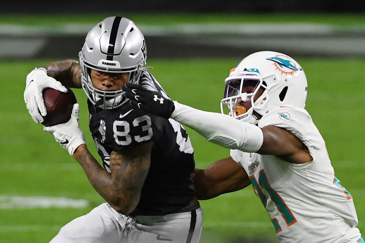 Darren Waller #83 of the Las Vegas Raiders makes a catch against free safety Eric Rowe #21 of the Miami Dolphins in the first half of their game at Allegiant Stadium on December 26, 2020 in Las Vegas, Nevada. The Dolphins defeated the Raiders 26-25.
