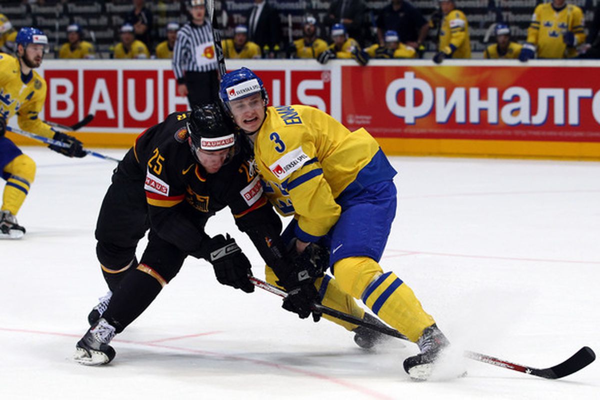  Oliver Ekman Laarson of Sweden blocks Marcel Mueller of Germany during the IIHF World Championship bronze medal match between Sweden and Germany.