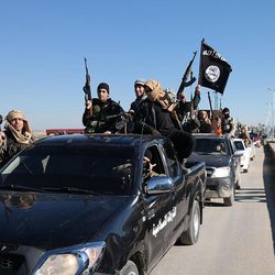 FILE - In this this file photo released on May 4, 2015, on a militant website, which has been verified and is consistent with other AP reporting, Islamic State militants pass by a convoy in Tel Abyad, northeast Syria. Germany's federal criminal police said Thursday, March 10, 2016 they are in possession of files containing personal data on members of the extremist Islamic State group and believe them to be authentic. (Militant website via AP, File)