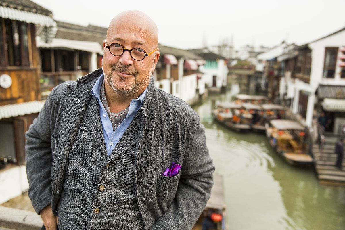 Bizarre Foods host Andrew Zimmern on a bridge in the ancient water town of Zhujiajiao in China