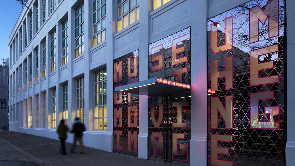 two people walk past Museum of the Moving Image front entrance