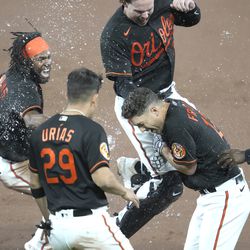 Adam Frazier #12 of the Baltimore Orioles is sprayed with water after driving in the winning run in the ninth inning during a baseball game against the Detroit Tigers at Oriole Park at Camden Yards on April 21, 2023 in Baltimore, Maryland.