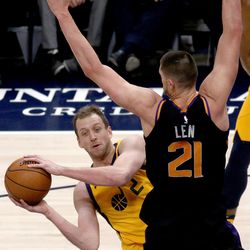 Utah Jazz forward Joe Ingles (2) looks to make a pass around Phoenix Suns center Alex Len (21) during a basketball game at the Vivint Smart Home Arena in Salt Lake City on Wednesday, Feb. 14, 2018.
