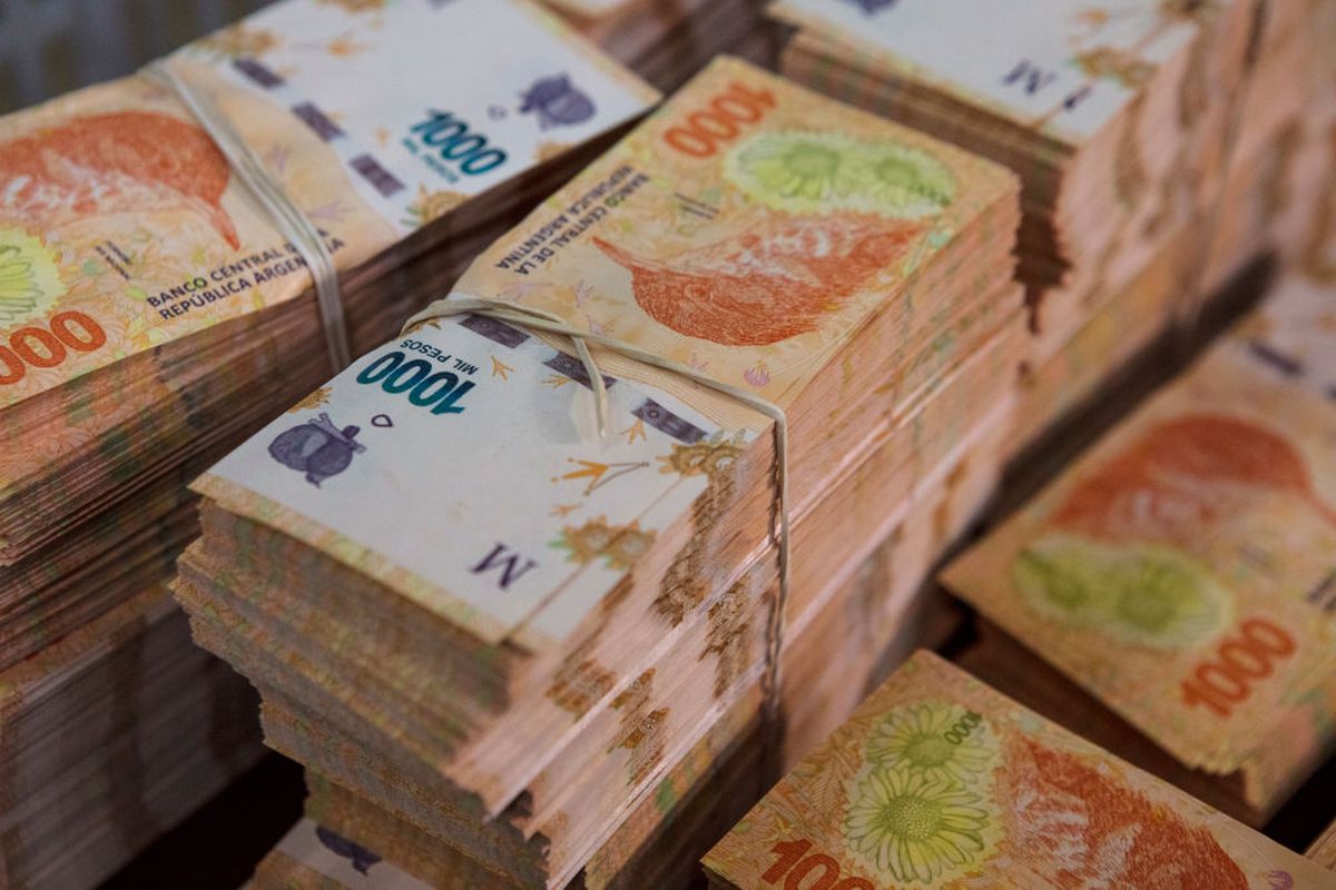 Piles of Argentine pesos.