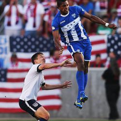 Honduras' Carlo Costly (13) goes high over Matt Besler (5) U.S. to head the ball as the United States and Honduras play Tuesday, June 18, 2013 at Rio Tinto Stadium. USA beat Honduras 1-0.