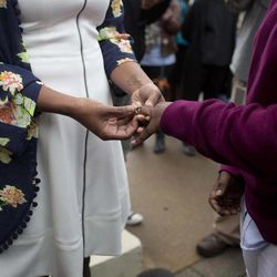 Tori Sisson, left, and Shante Wolfe, right, exchange wedding rings during their wedding ceremony, Monday, Feb. 9, 2015, in Montgomery, Ala.  Sisson and Wolfe are the first couple to file their marriage license in Montgomery County. Alabama is the 37th state to allow gays and lesbians to wed. 