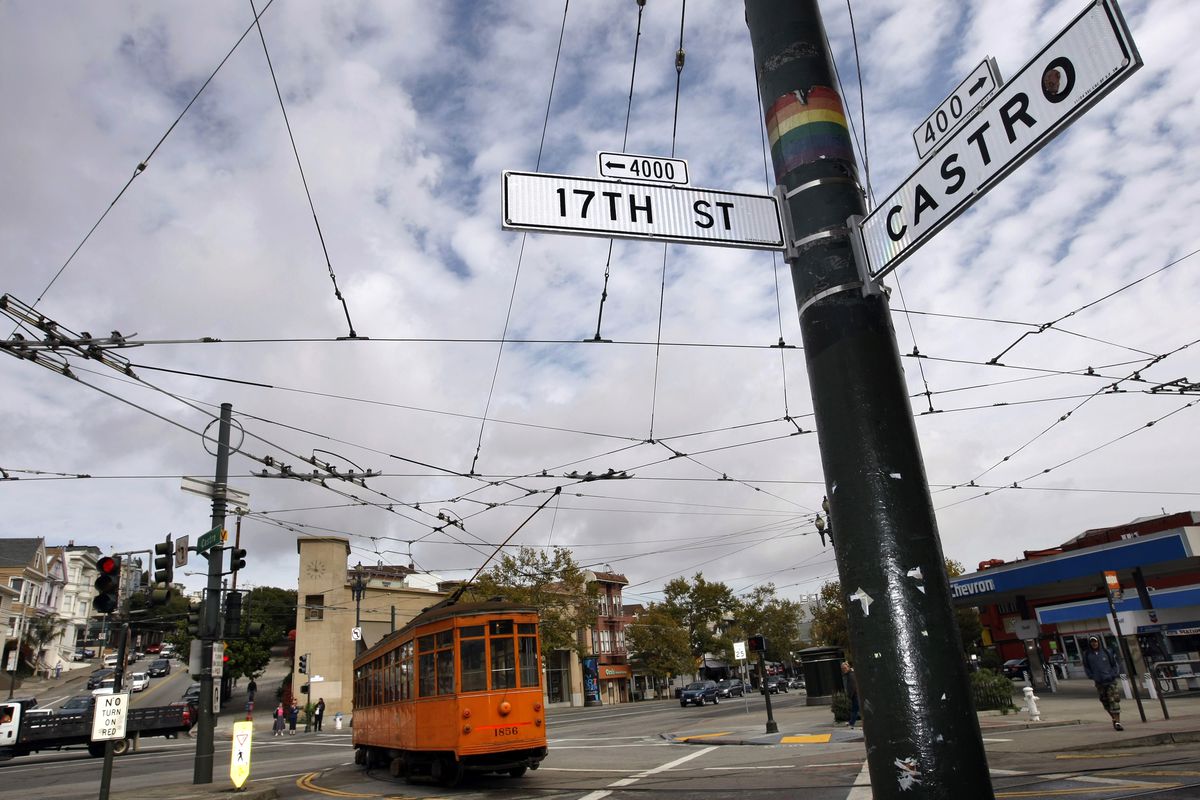 A street car passes through the intersection of Castro and 1